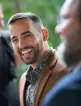 A photo of clerk Doug Ruccione smiling and laughing, with others around him but out of focus. 
